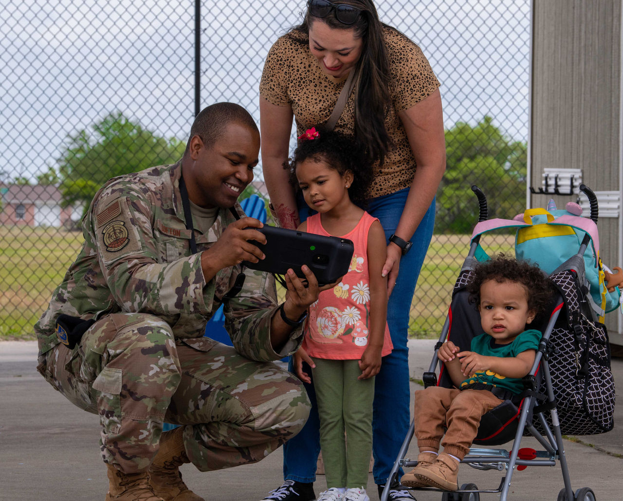 U.S. Air Force Tech. Sgt. Billy Lofton, 325th Security Forces Squadron, noncommissioned officer in charge of plans, shows his family how to operate an unmanned ground vehicle at Tyndall Air Force Base, Florida, April 29, 2022. Lofton’s family participated in the family carnival event celebrating the Month of the Military Child. (U.S. Air Force photo by Airman 1st Class Zachary Nordheim)