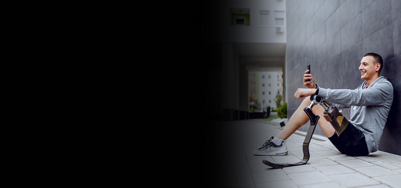 A photograph of a young man with a prosthetic leg